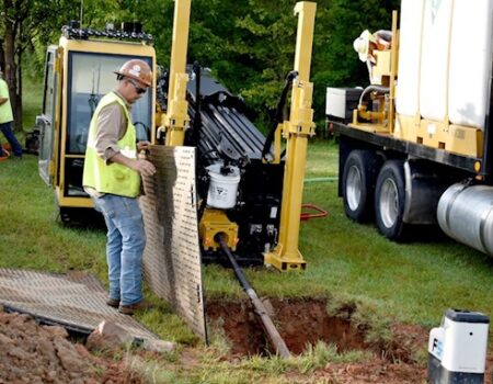 Placing mud boards on top of rock which will help prevent splashing materials on the drill
